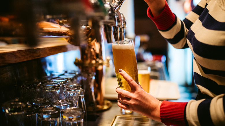 Beer tapping into a drinking glass