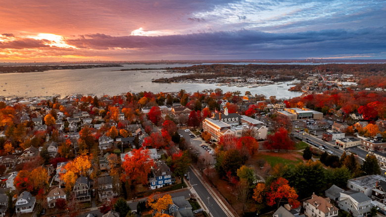 Aerial view of sunset over Port Washington, with fall foliage lining the streets