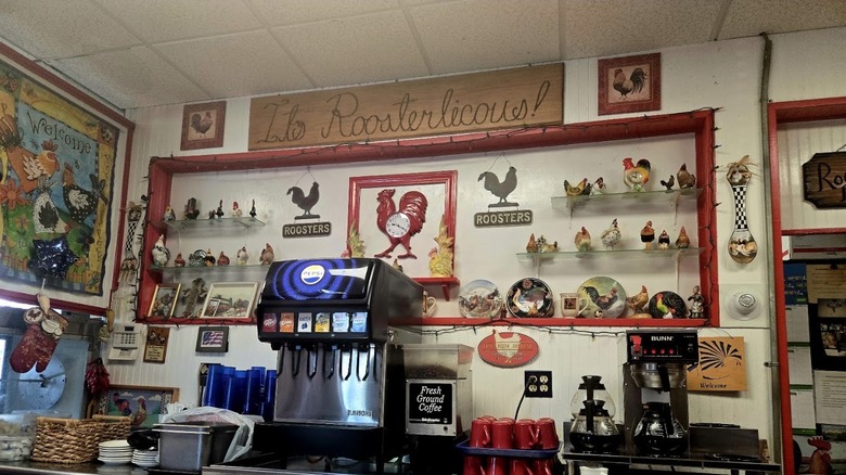 The several rooster-themed decorations, including a large "It's Rooosterlicious!" sign, at Rooster's Cafe in Lackawanna, New York.