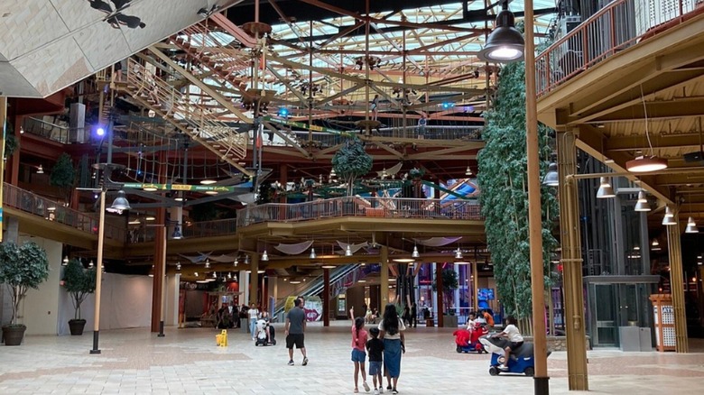The interior of Destiny USA with three people looking up at how big it is