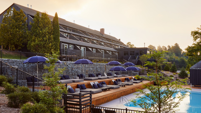 a hotel with lounge chairs and a pool in the Catskills