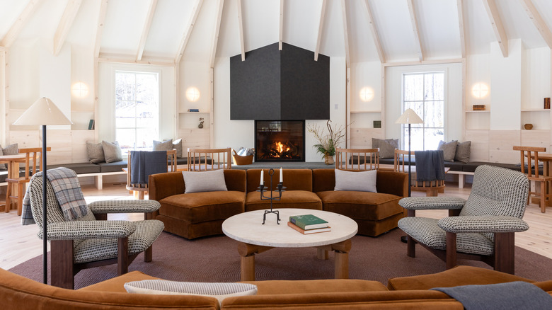 a cozy hotel lobby with couches and a fireplace
