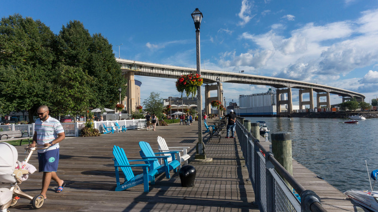 Man with stroller walking along waterfront in Buffalo