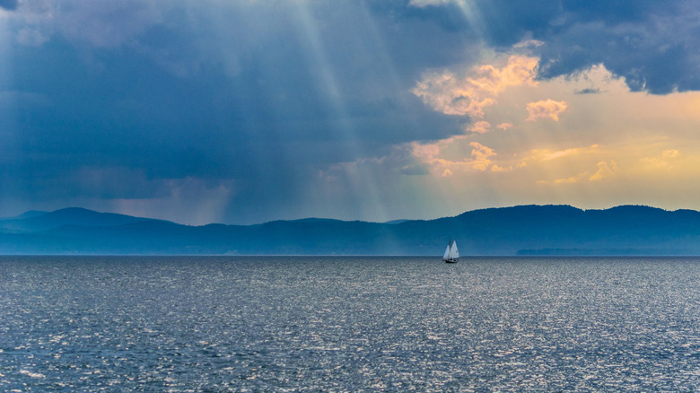 Sunbeams and a sailboat on Lake Champlain