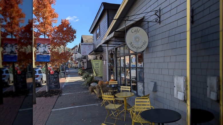 Cafe Marguerite, with its checked window and yellow tables on the street, in the fall