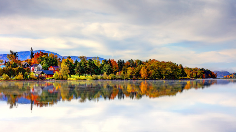 A reflection of the town of Tupper Lake over the water