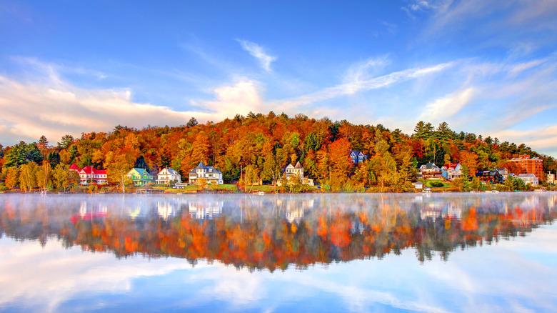 The village of Saranac Lake in New York, with quaint homes nested in trees by the lake