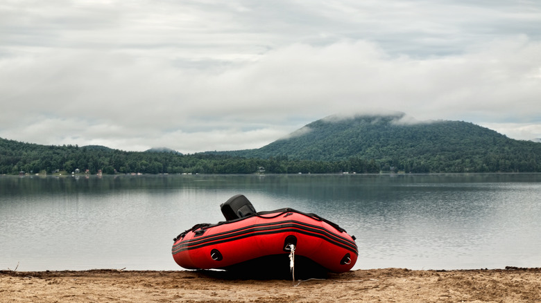 A red raft boat on the sandy beach of Moffitt Beach Campground