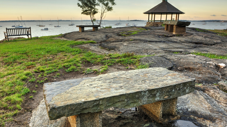 Stone bench overlooking the water in Larchmont Manor Park, New York