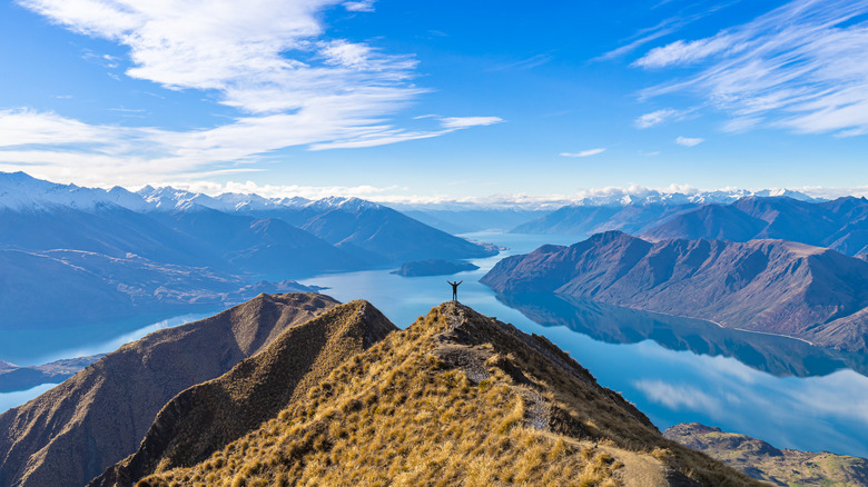 A hiker on top of Roy's Peak in Wanaka overlooking Lake Wanaka
