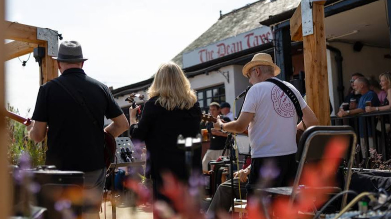 People with brinks in their hand watching a band play at The Dean Tavern in Newtongrange