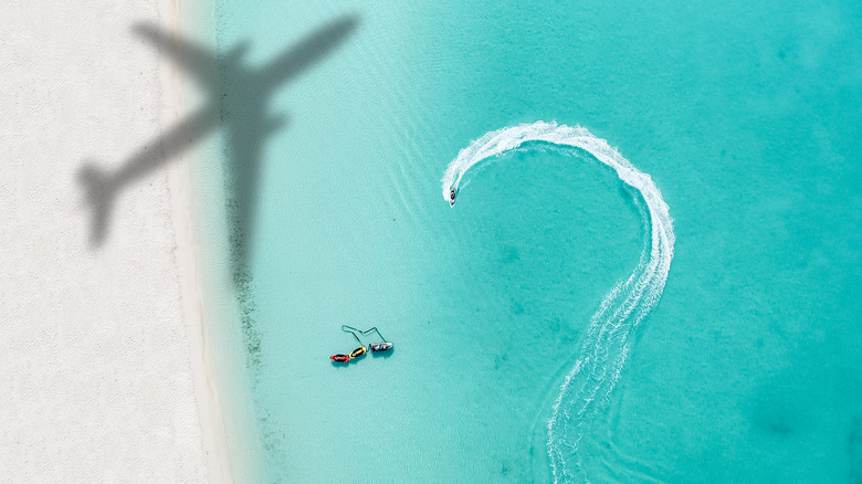 A plane flying over a beach