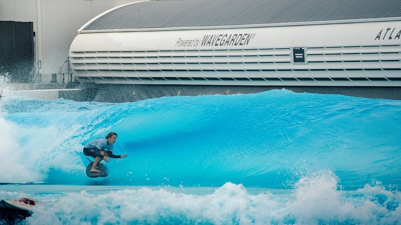 Surfer riding an artificial wave at Atlantic Park Surf
