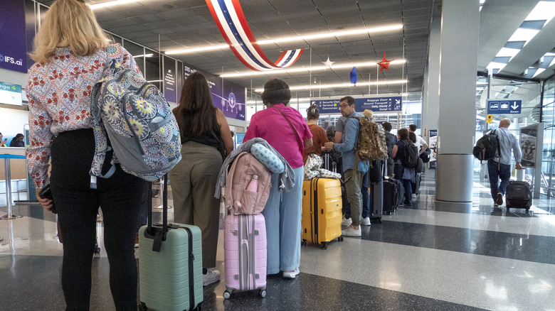 Passengers waiting in line to check in for their flight at Chicago O'Hare International Airport