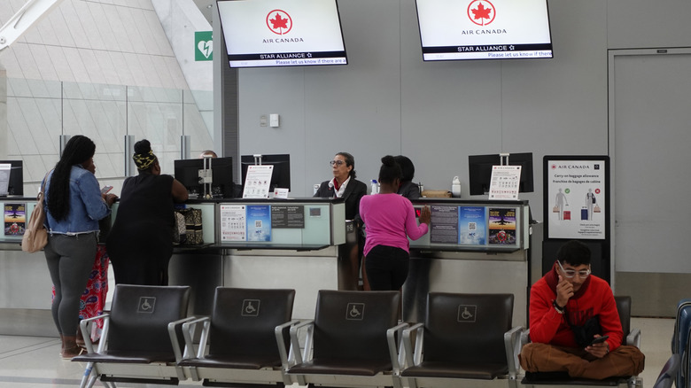 People checking in for an Air Canada flight at Toronto Pearson International Airport.