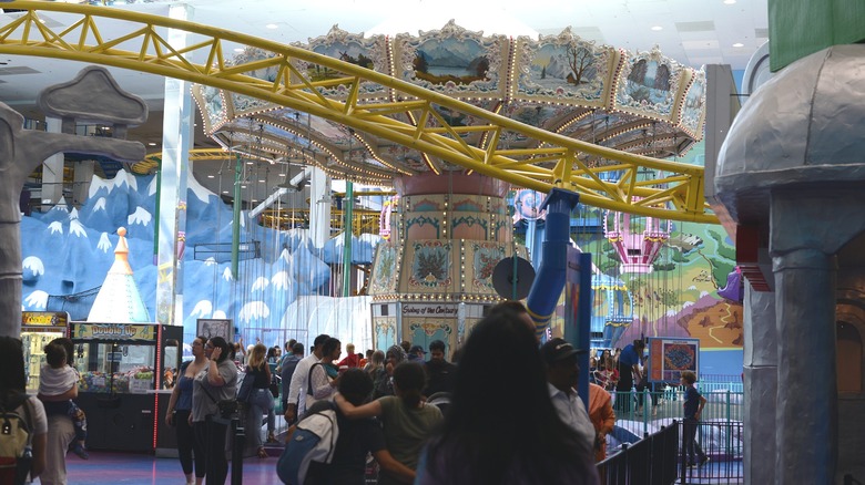 Visitors stroll by carousel at Galaxyland at Edmonton Mall