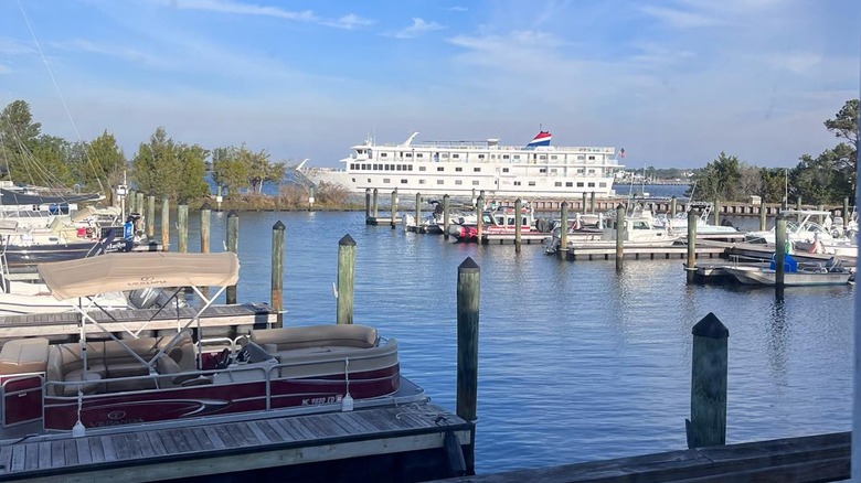 A small cruise ship passes the small boat marina at Carolina Beach State Park