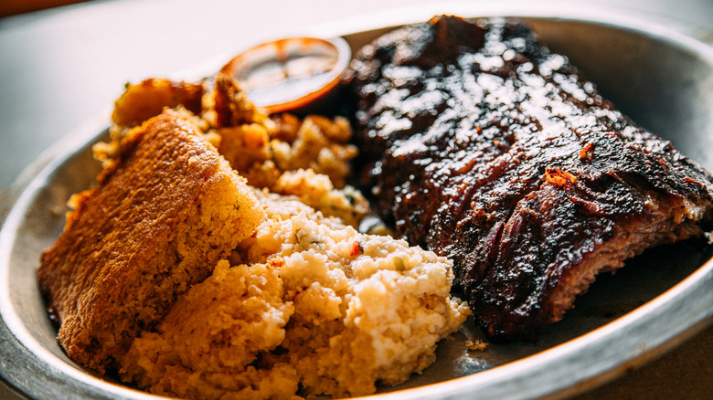 A plate of barbecue ribs and cornbread