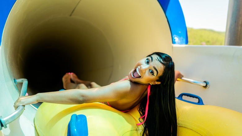 Young woman on a waterpark slide