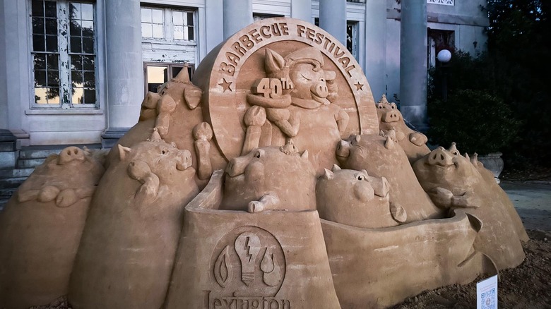 A massive pig-themed sand sculpture sits at the site of the Lexington Barbecue Festival