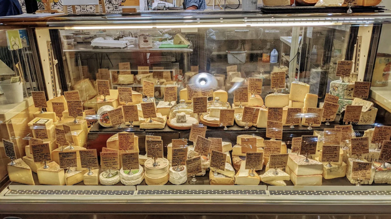 Large selection of cheeses in a glass case at Orrman's Cheese Shop
