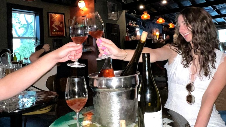 A couple clinking their wine glasses at Substrate