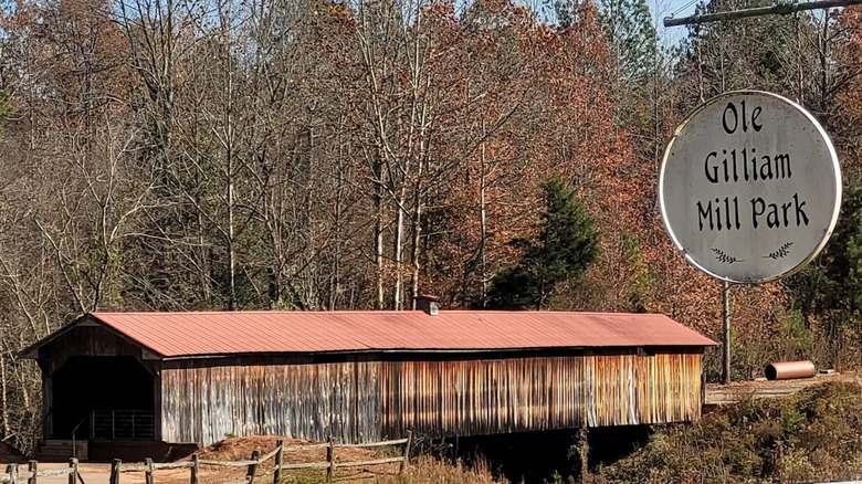 Ole Gilliam Mill Park sign in the foreground with North Carolina's longest covered bridge in the background