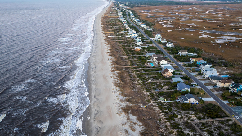 Aerial view beach homes lining the coast of Oak Island