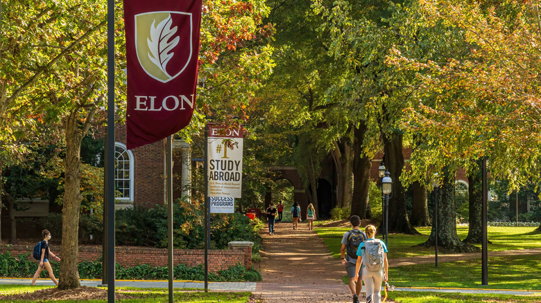 Elon University campus with students walking on pathways under trees