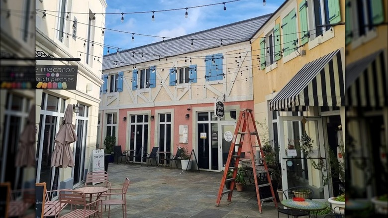 Cobblestone streets and pastel al fresco furniture backdropped by Paris-style buildings in Lafayette Village, North Raleigh