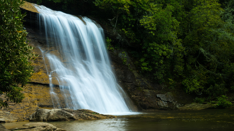 water of Silver Run Falls cascades into shaded pool near Cashiers, North Carolina