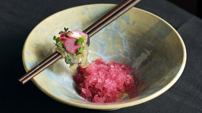 Macro shot of a unique sorbet-like dish served in a decorative bowl with chopsticks resting on top at Counter-