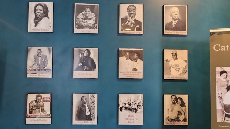 A wall with black and white photos of famous Magnolia House guests