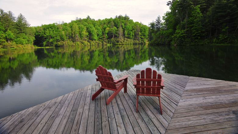 Two empty deck chairs on a dock at Lake Toxaway in North Carolina