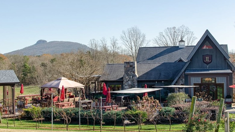 The exterior of Jolo Vineyards and End Posts restaurant with Pilot Mountain in the background