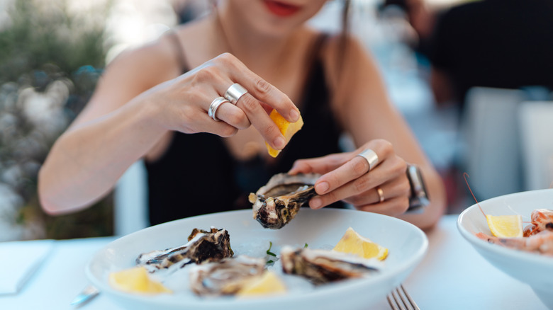 A woman enjoying fresh oysters