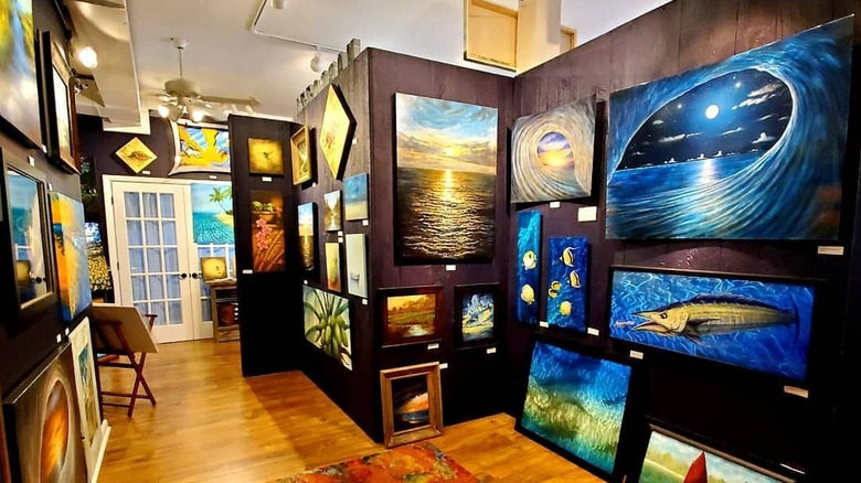 Paintings hung on The Path Art Gallery's walls in Salter Path, NC