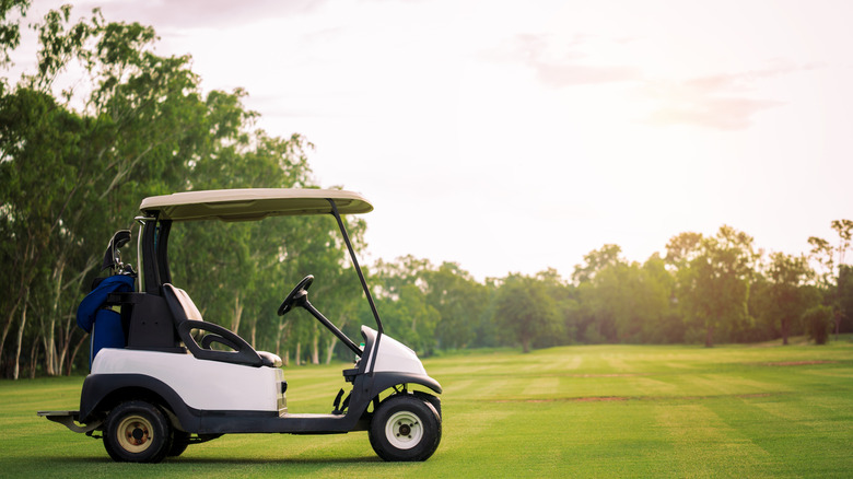Golf cart on a green golf course