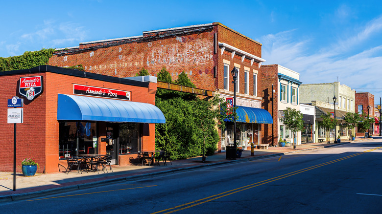 Historic buildings housing shops and restaurants along the main street in Downtown Zebulon on a sunny day.