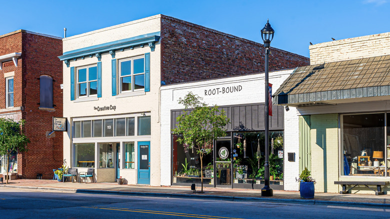 Outside The Creative Cup in Zebulon with outdoor seating in the sunshine and a neighboring plant shop.