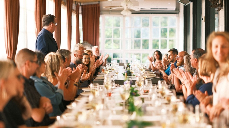 Family-style dining at The Silo Cookhouse with guests chatting to each other and farm to table cuisine