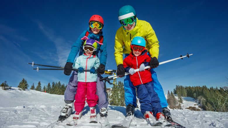 A family wearing skiing gear at a ski resort