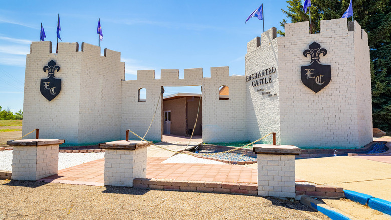 White-brick castle building under a blue sky
