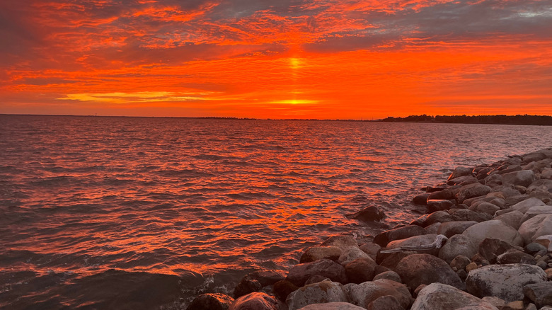 a red sky sunset from the shore of Devils Lake in North Dakota