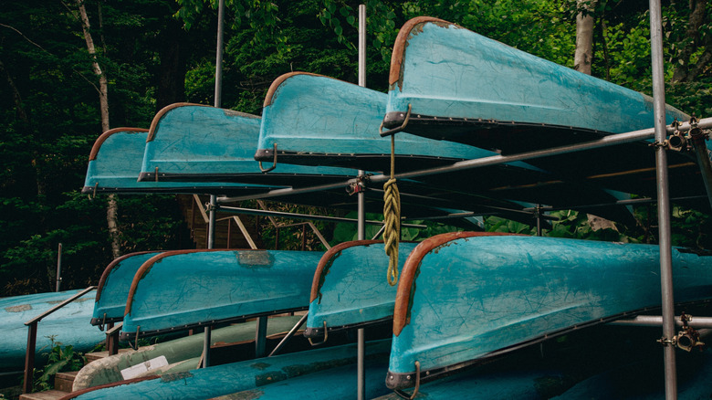 Image of a row of canoes upside down at a dock