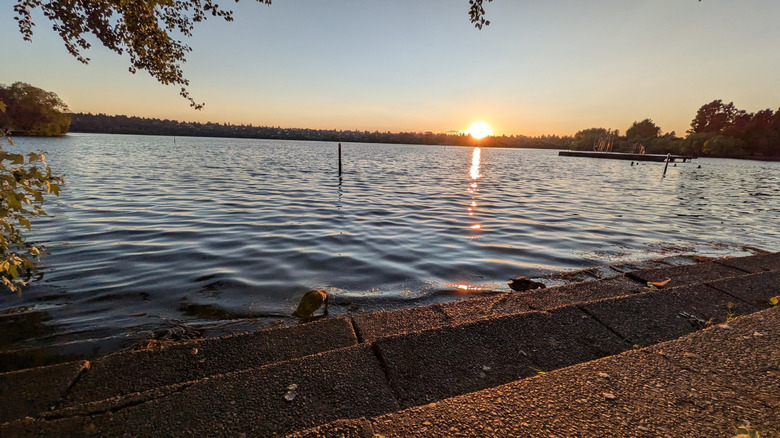 Sunset at the Green Lake Swimming Area, with its floating dock in the water, in Green Lake Park in the Green Lake neighborhood of Seattle, Washington