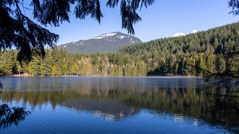 Alice Lake with mountain reflection and morning mist at Alice Lake Provincial Park, Squamish, Canada