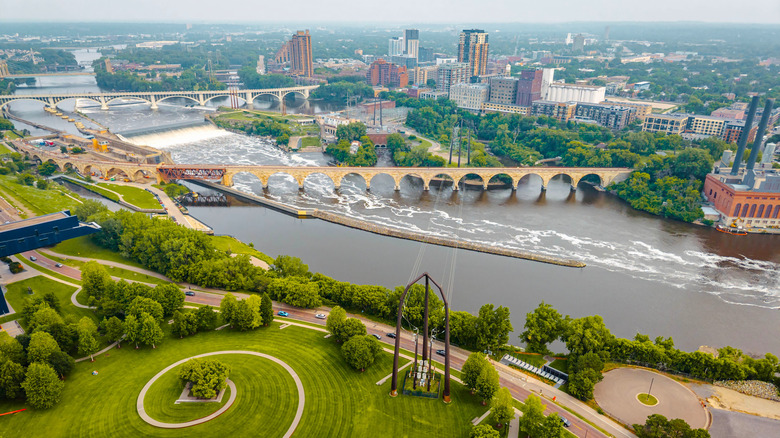 Aerial view of Minneapolis with the Mississippi River, bridges, and a spiral green park