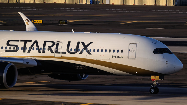 Aircraft of Starlux Airlines arrives at Phoenix Sky Harbor International Airport around sunset