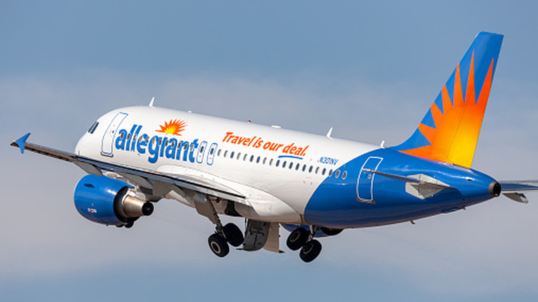 An Allegiant Air passenger plane flying in the sky.